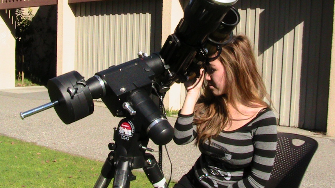 Female student looking through Telescope