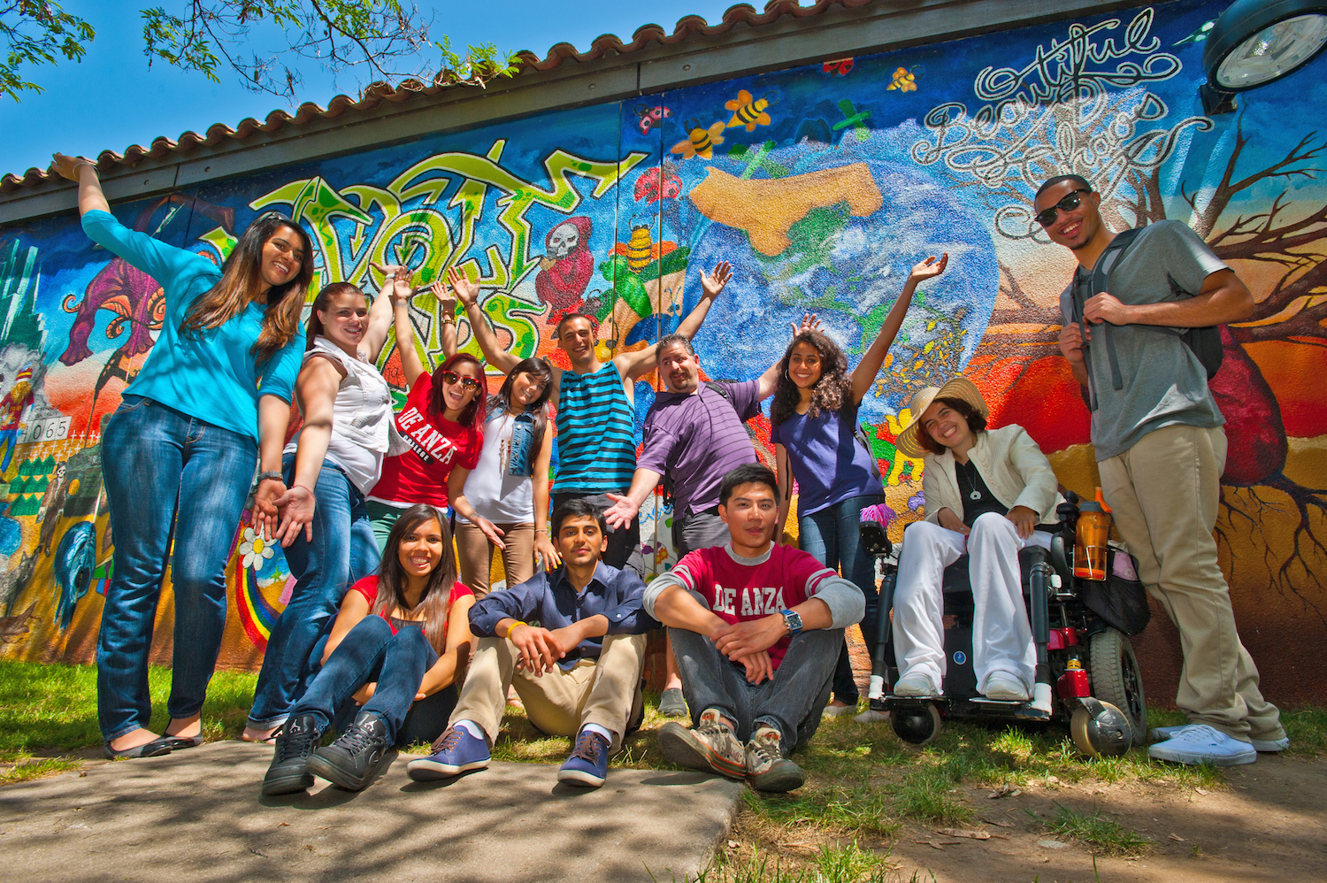students standing in front of Chaos mural