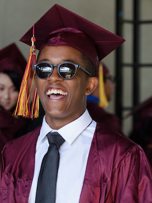 young grad guy with sunglasses