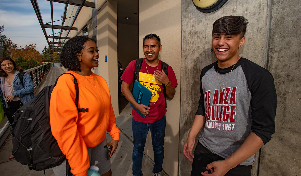 three students laughing together