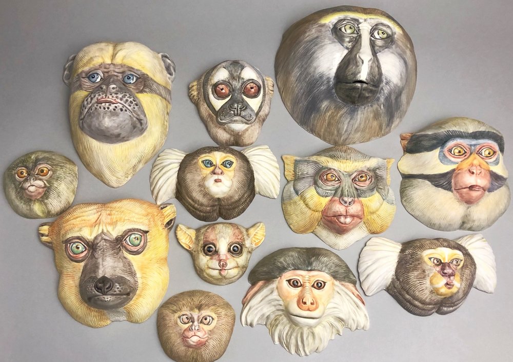 sculpted masks of ape faces