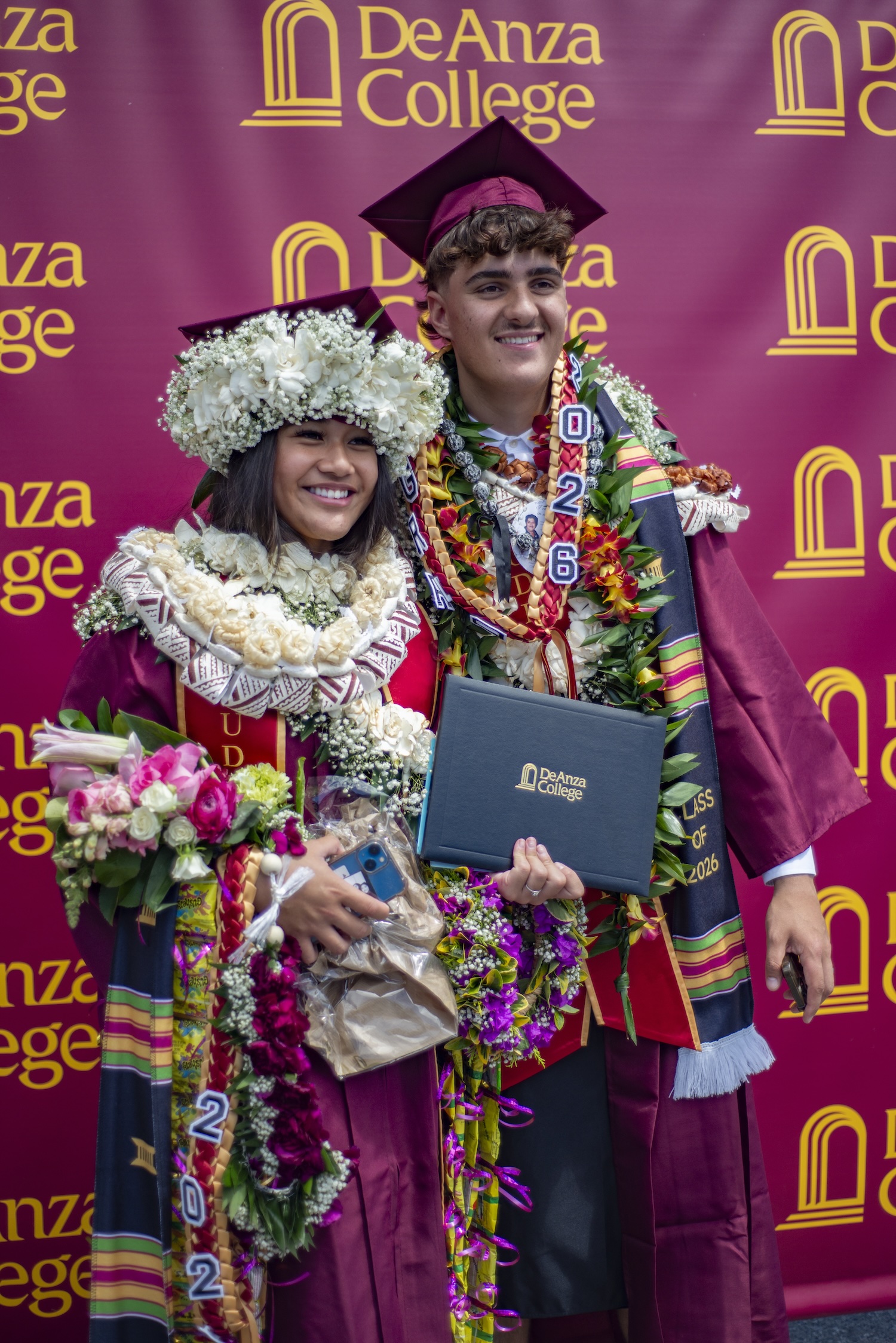 Two grads pose after commencement