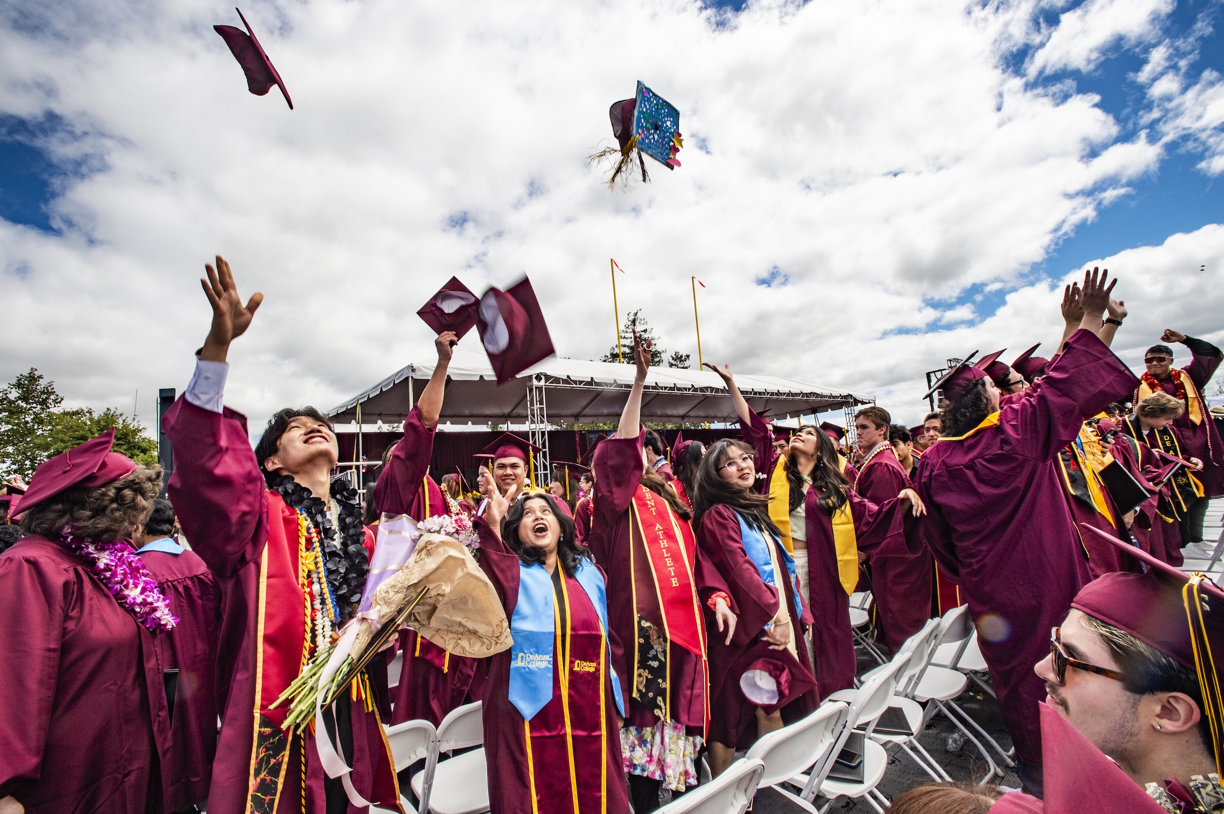 Grads toss their caps after the ceremony