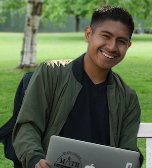 smiling young man with laptop computer