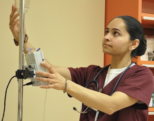 nursing student checking IV line