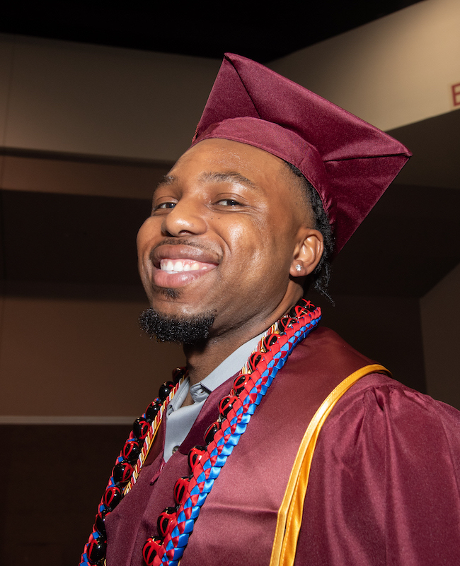 smiling young man in grad cap