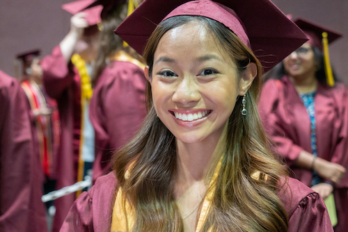 smiling young woman in grad cap