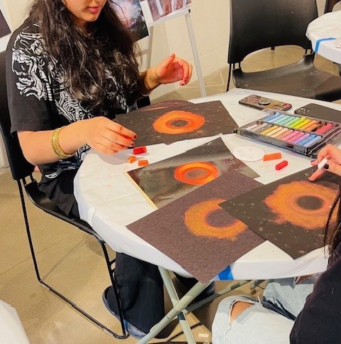 student at art table