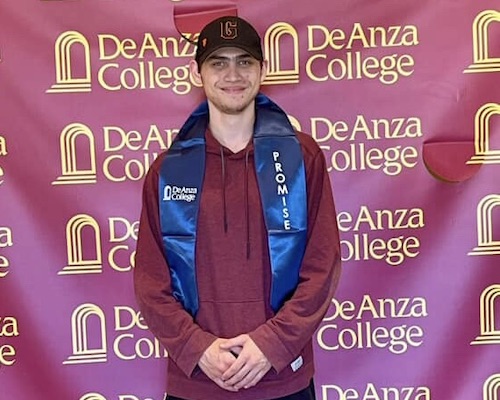 student with blue grad sash