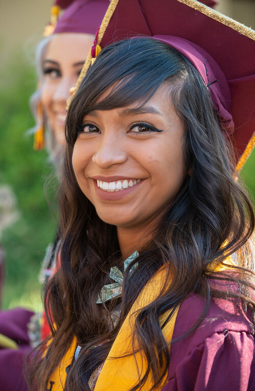 smiling young woman in grad cap looking to her left