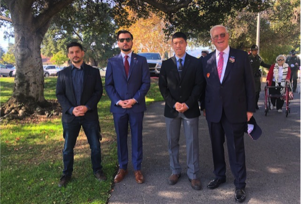 Gabriel Medina in suit with three other men in suits, standing outdoors