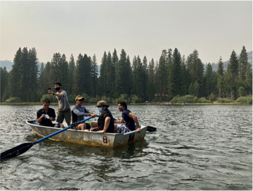 Ehud Silitonga in rowboat with other men on lake